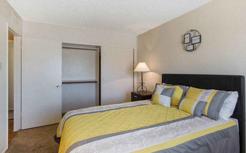 a bedroom with a bed and a door to a bathroom