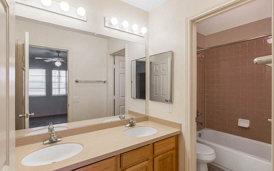 a bathroom with two sinks and a mirror