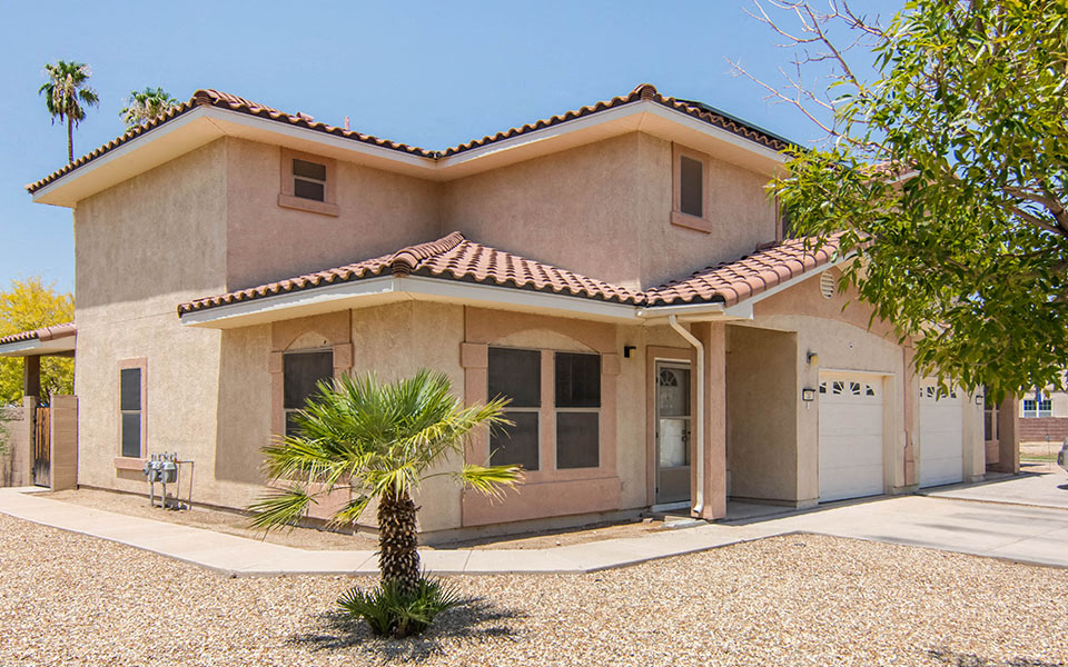a house with a palm tree in front of it