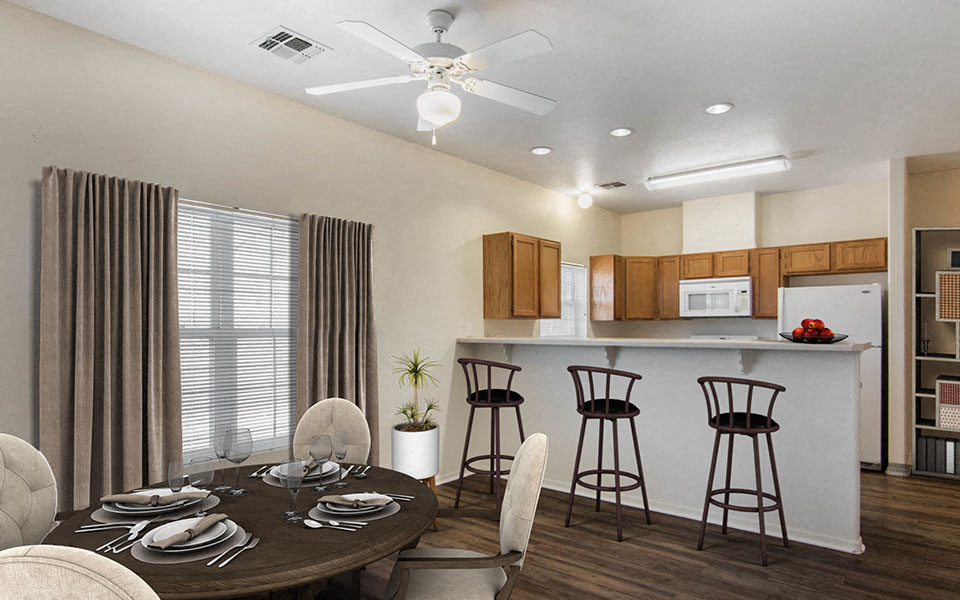 a dining room and kitchen with a table and chairs