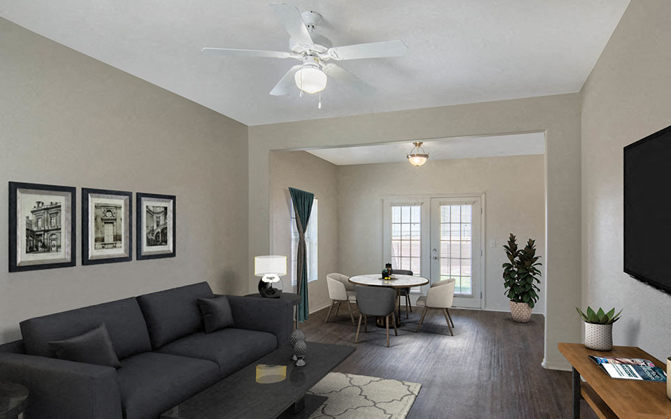 a living room with a couch and a ceiling fan