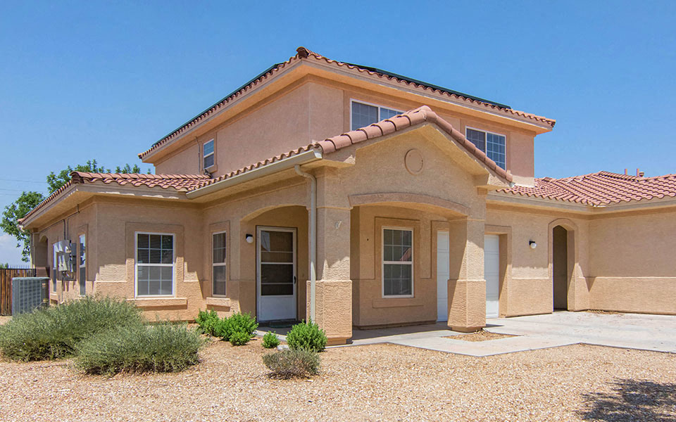 a house with a front door and a gravel driveway