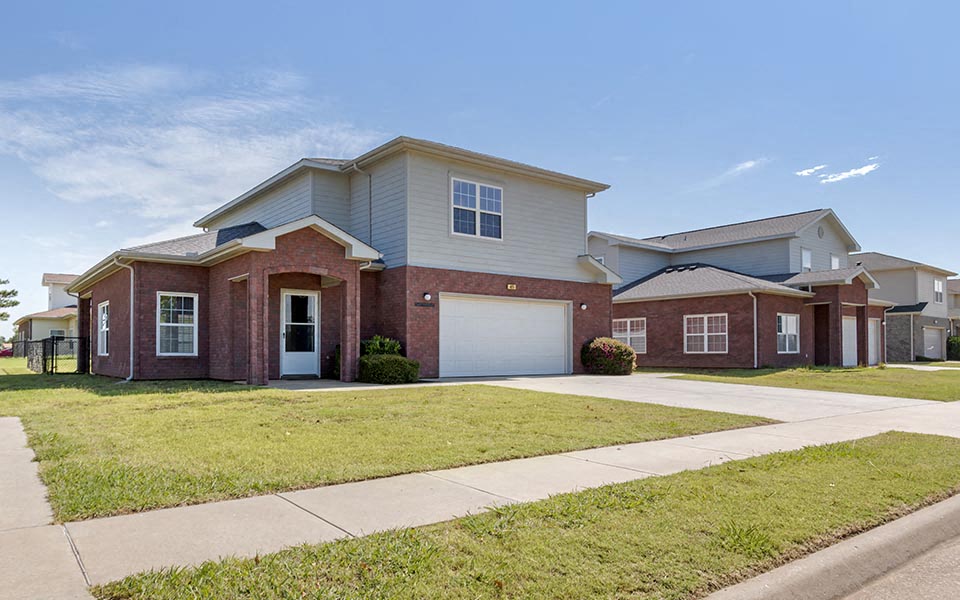 a red brick house with a white garage door