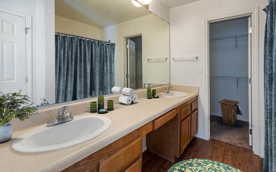 a bathroom with two sinks and a large mirror