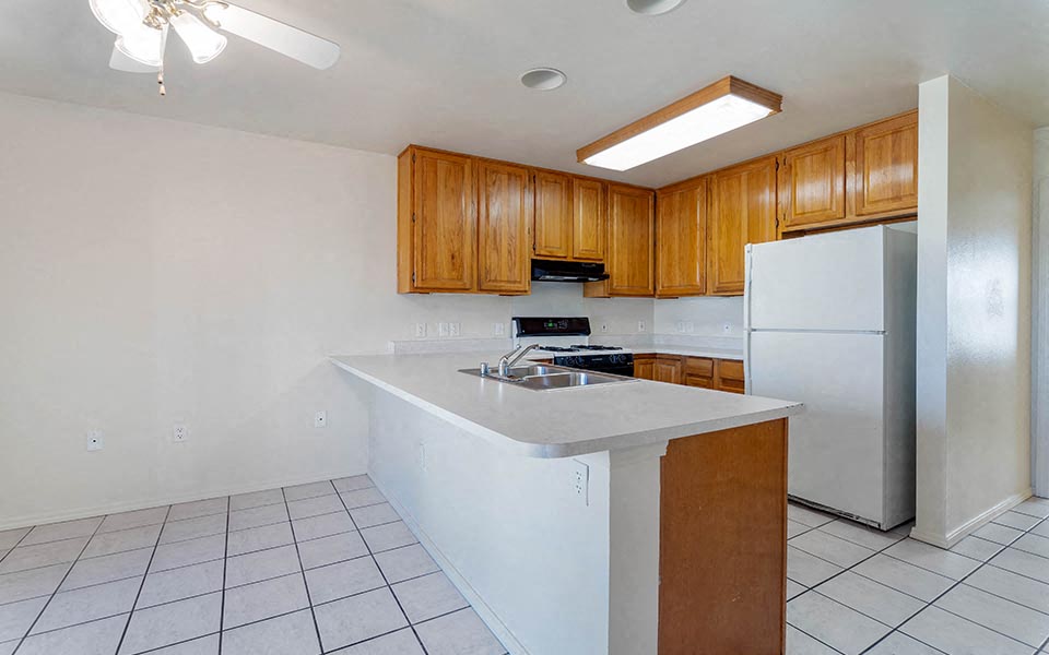 a kitchen with a counter top and a refrigerator