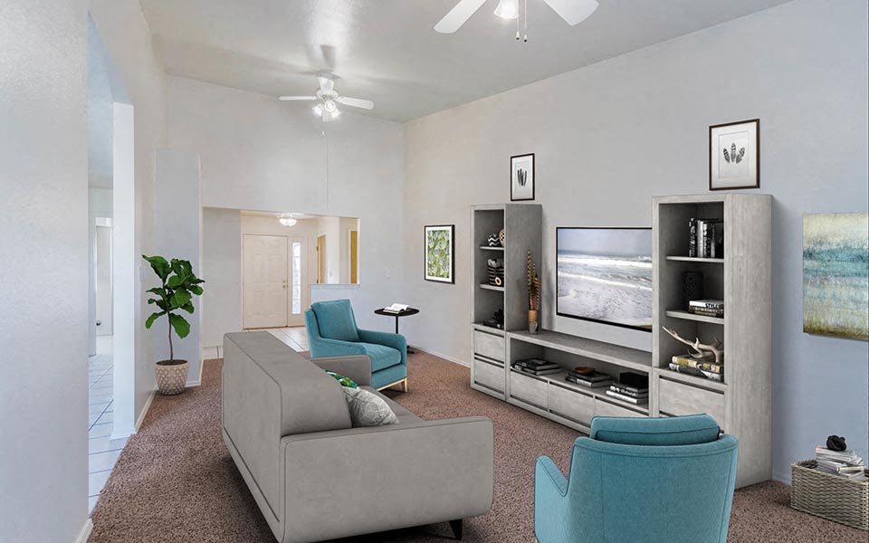 a living room with a couch and chairs and a television