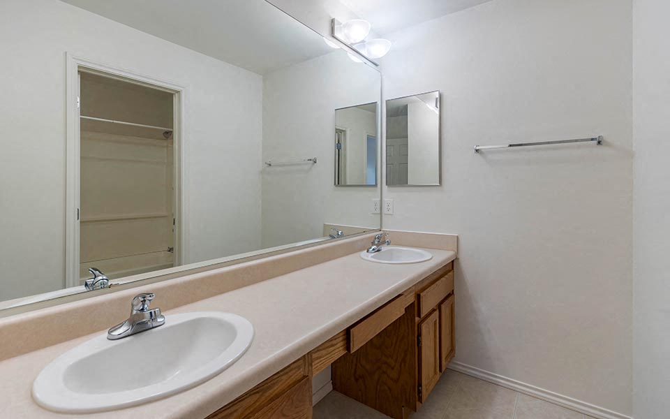 a bathroom with two sinks and a mirror