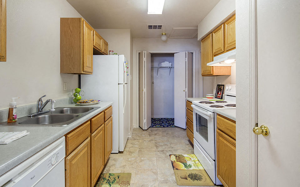 a kitchen with a sink and a refrigerator