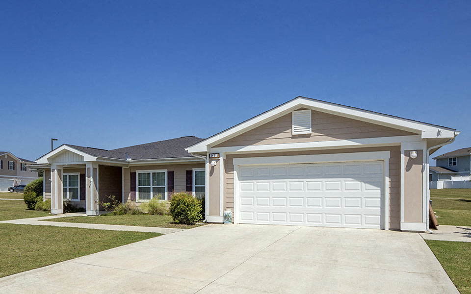 a house with a driveway and a garage door