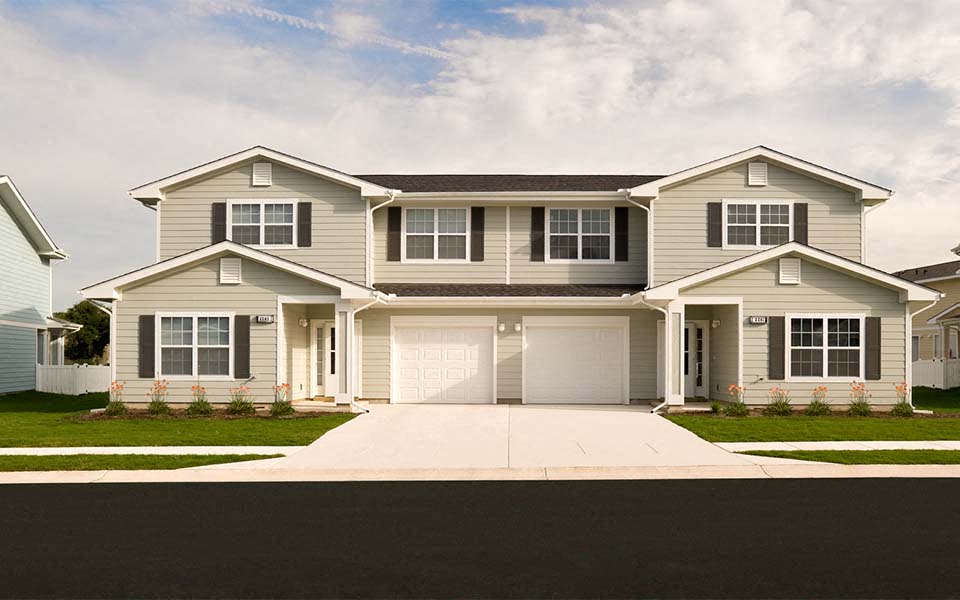 a white house with a garage and a driveway