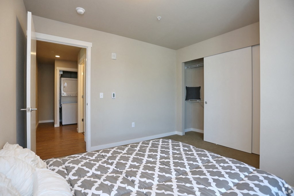 a bedroom with a bed and a closet and a bathroom