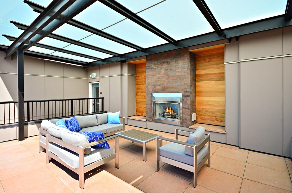 a living room with a couch and chairs and a fireplace