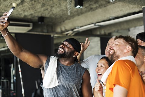 a group of people standing in a gym posing for a picture