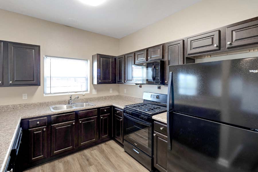 a kitchen with stainless steel appliances and wooden cabinets