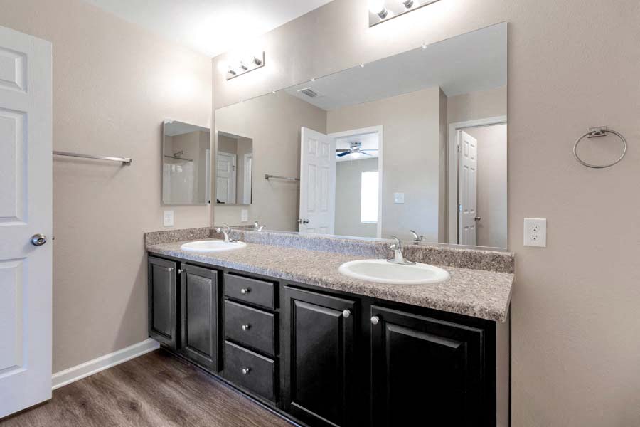 a bathroom with two sinks and a large mirror