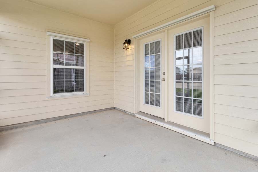 a porch with two windows and a door