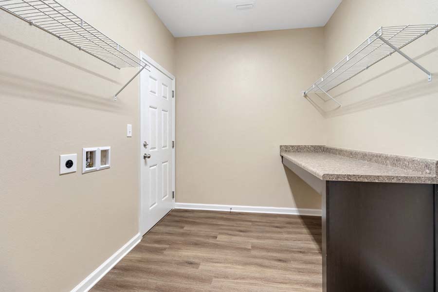 an empty kitchen with a door to a closet