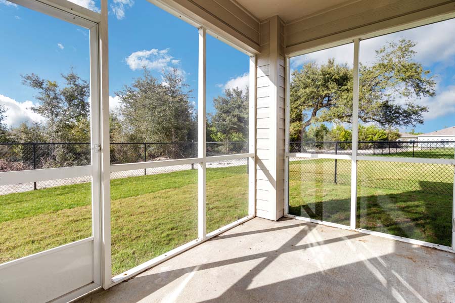 a balcony with a view of the yard and the grass