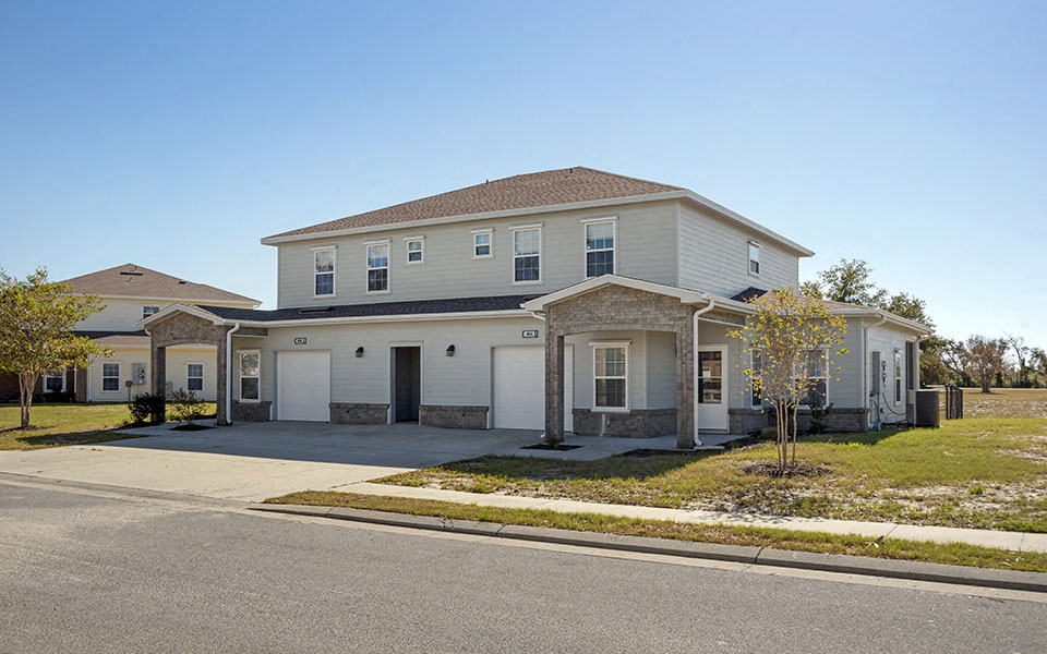 a large white house with a street in front of it