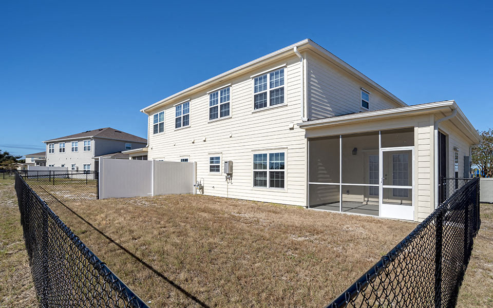 a white house with a yard and a fence