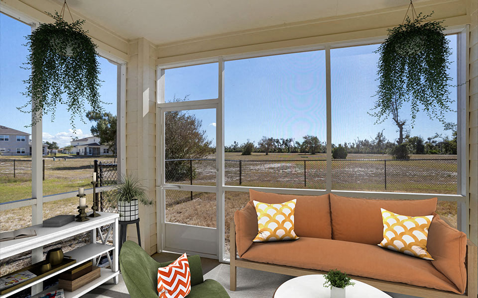 a screened in porch with a couch and windows