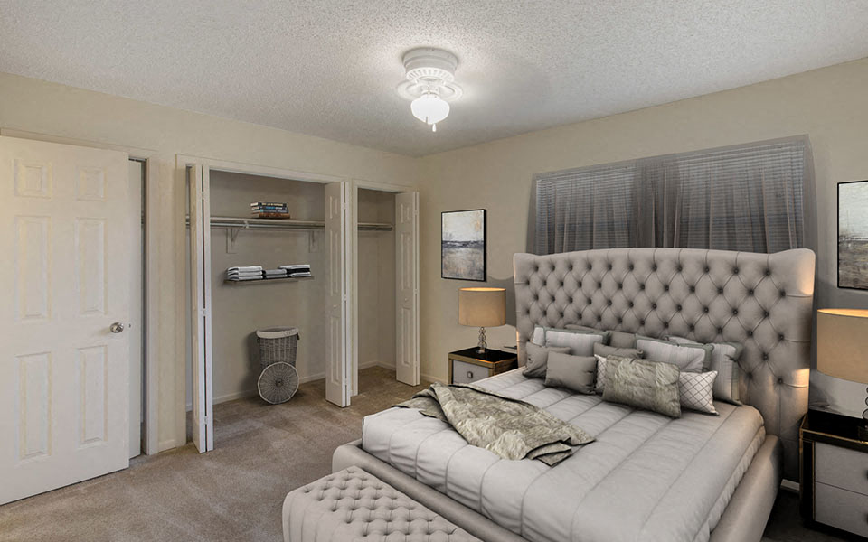 a bedroom with a large bed and a closet