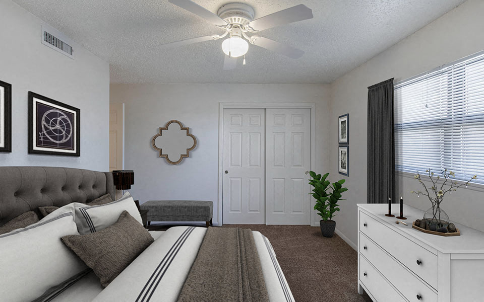 a bedroom with a bed and a ceiling fan