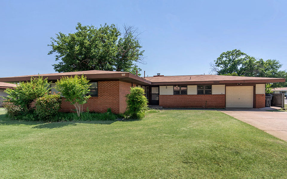 a brick house with a lawn in front of it