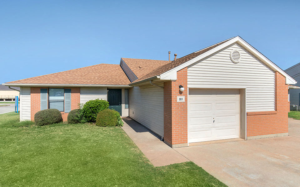 a house with a white garage door and a lawn