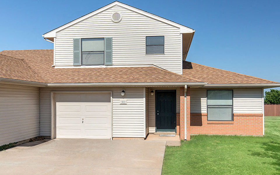 a white house with a white garage door