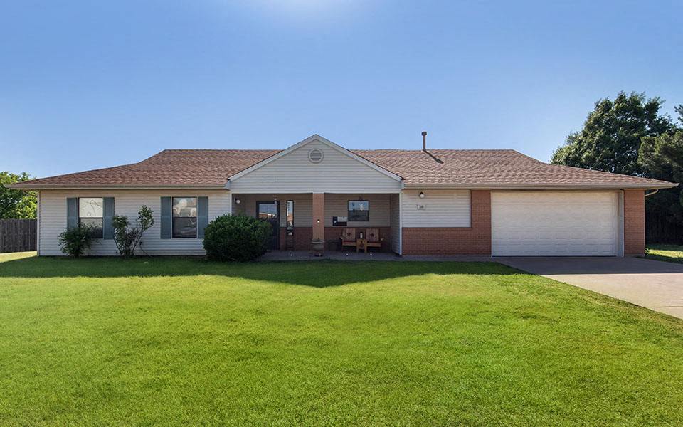 a white house with a lawn in front of it
