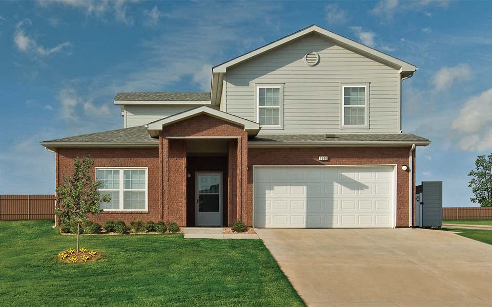 a brick house with a white garage door