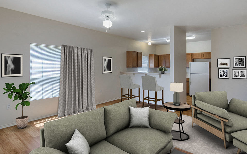 a living room with a couch in front of a kitchen