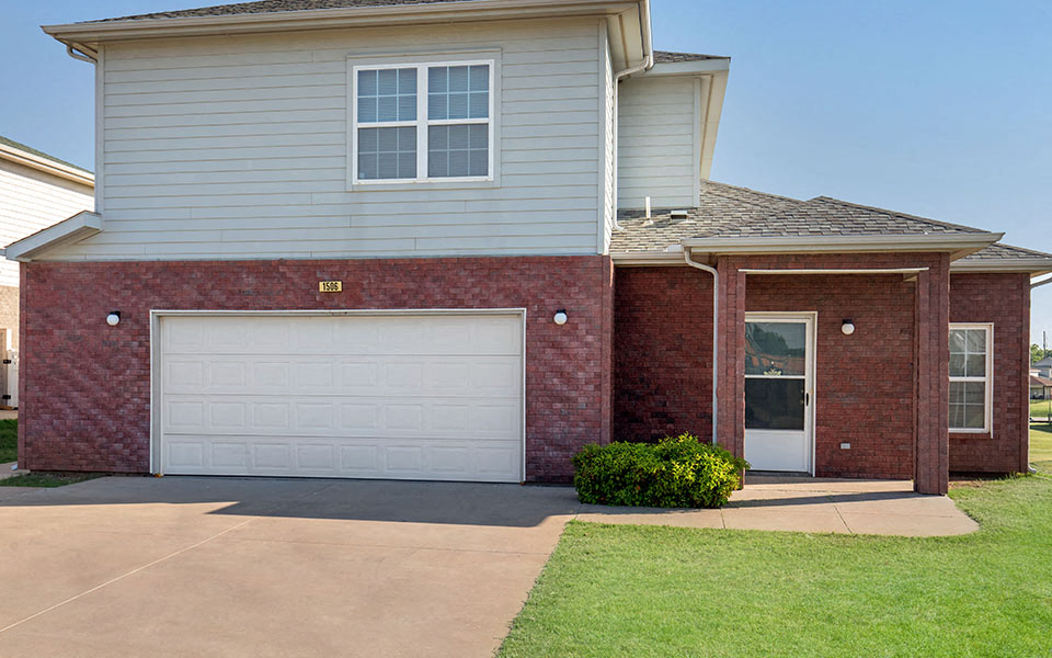 a brick house with a white garage door