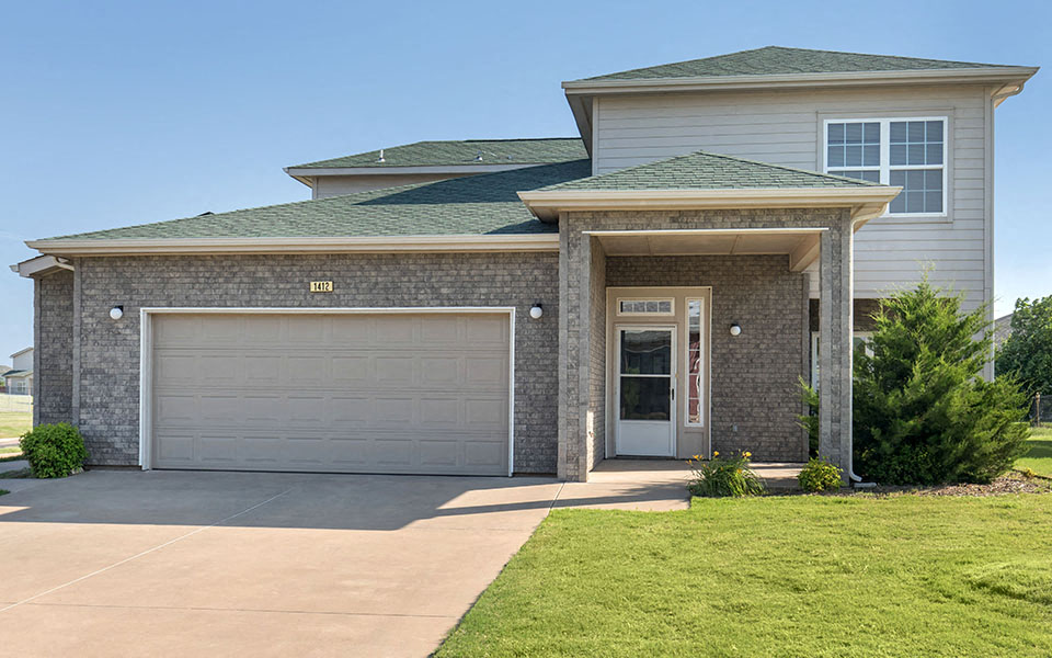 a house with a driveway and a garage door