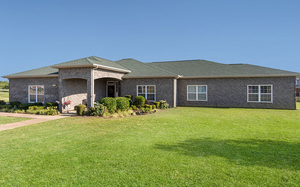 a house with a green lawn in front of it