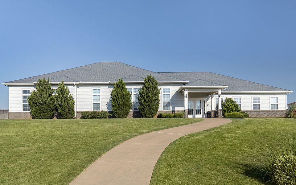 a white house with a walkway in front of it