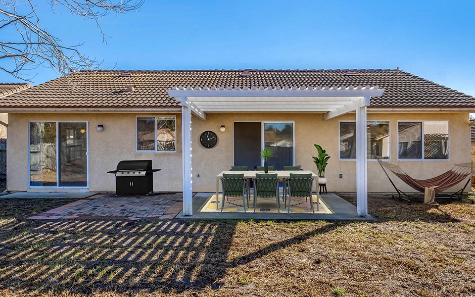 a house with a patio and a table and chairs
