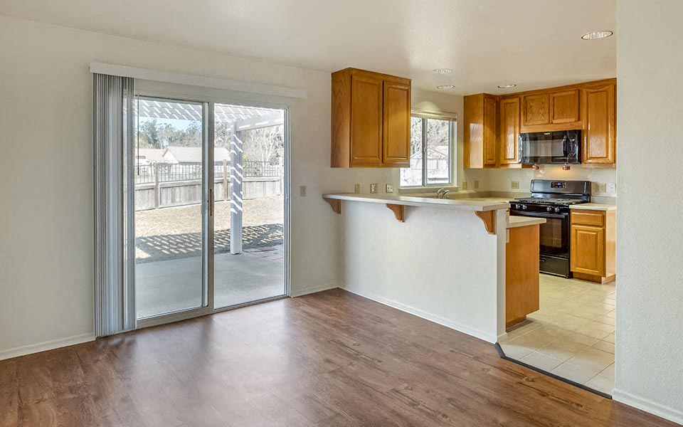 an empty kitchen with a door to the patio
