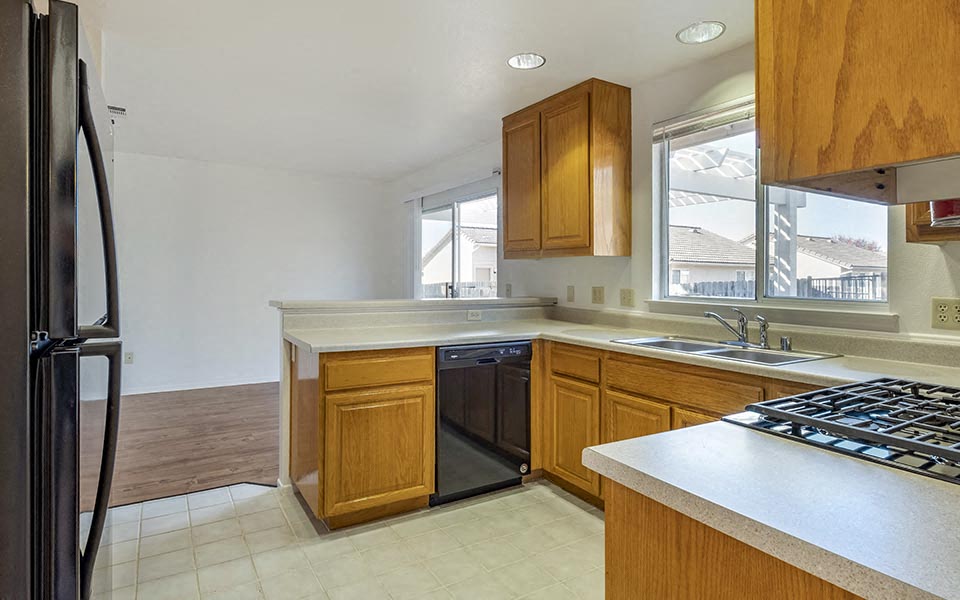 a kitchen with a stove top oven and a sink