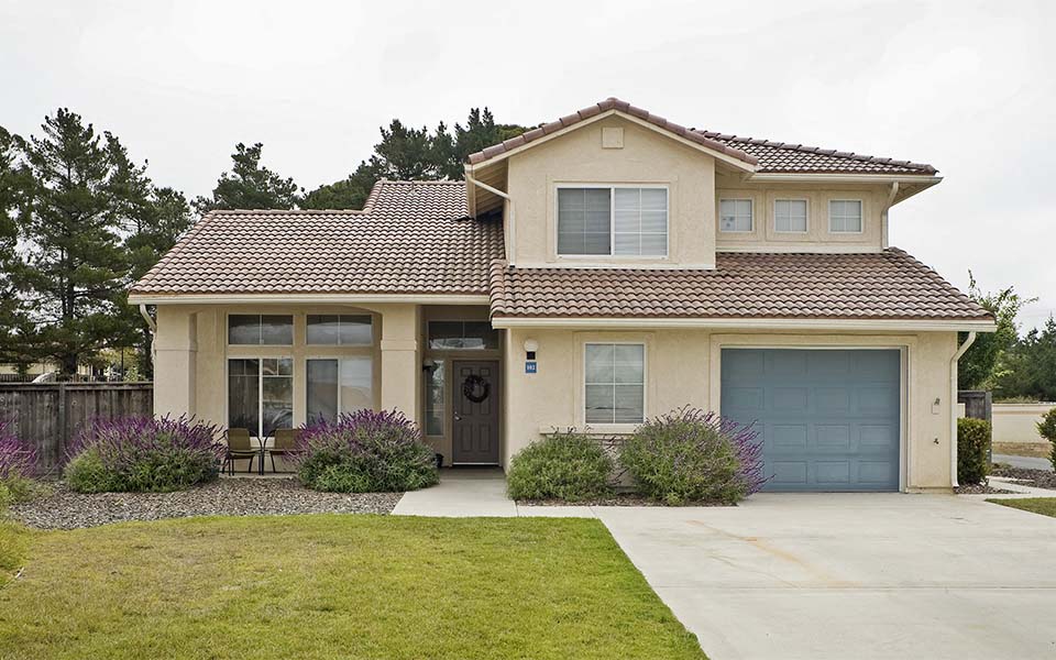 a beige house with a blue garage door