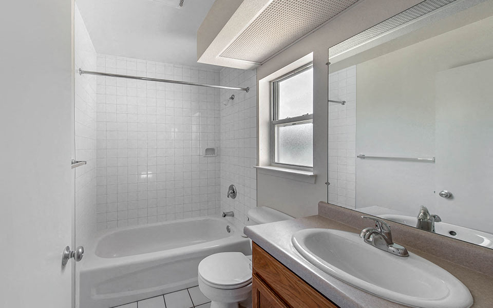 a bathroom with a sink toilet and a bath tub