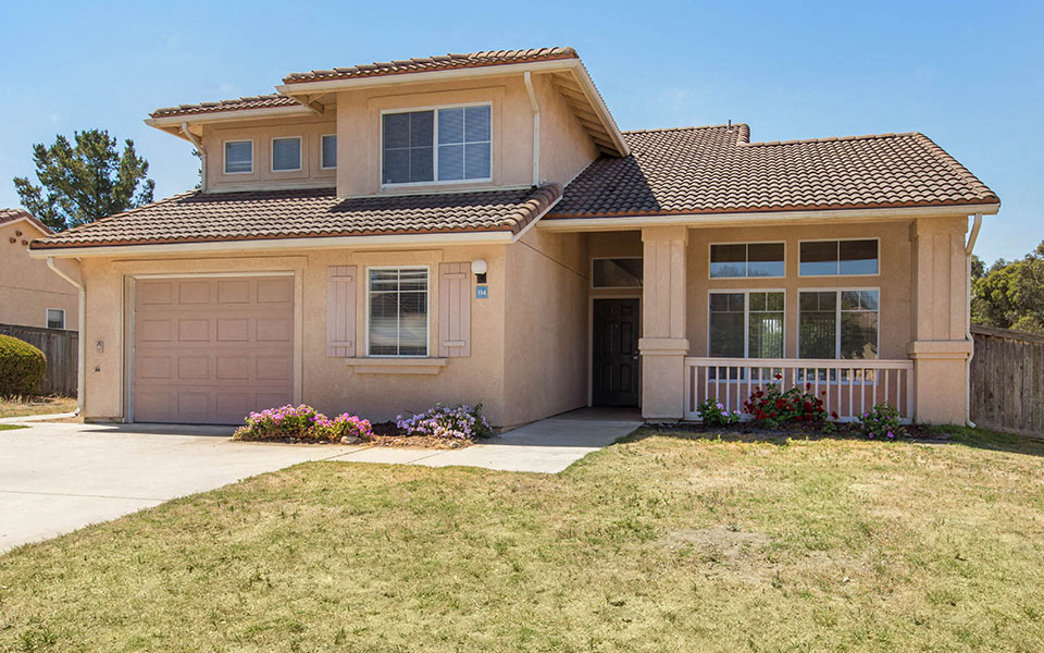 a house with a sidewalk in front of it
