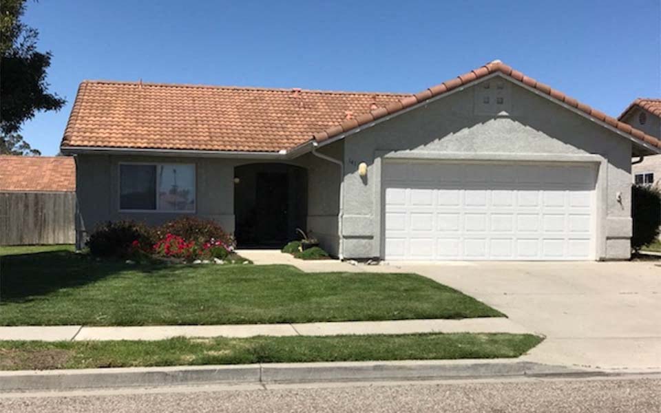 a house with a white garage door in front of it
