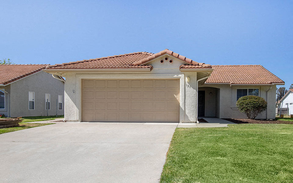 a house with a driveway and a garage door