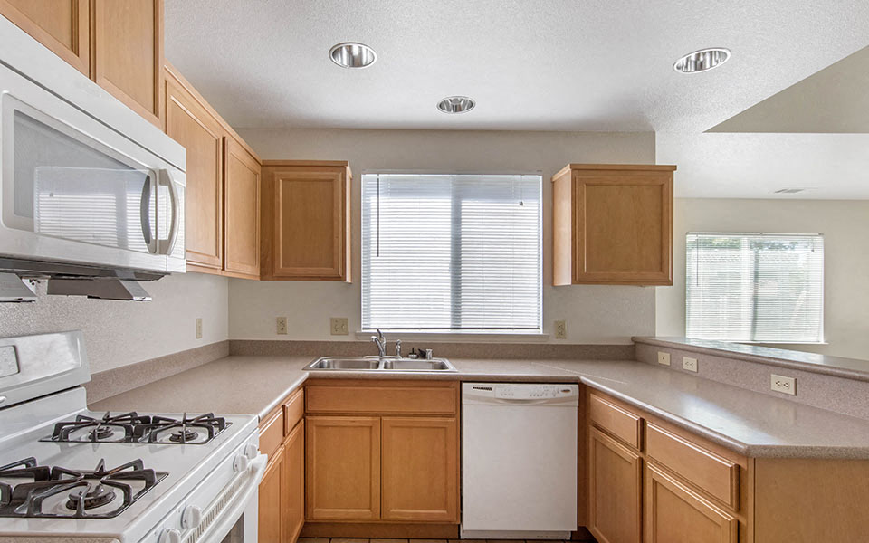 a kitchen with a stove top oven and a sink