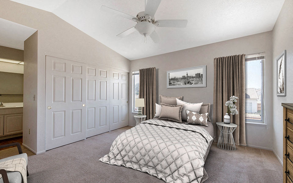 a bedroom with a bed and a ceiling fan