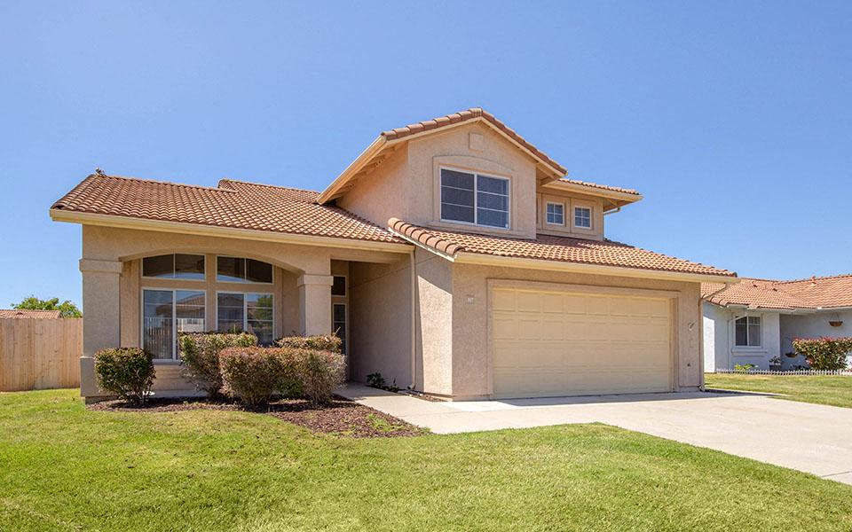 a house with a garage door and a lawn