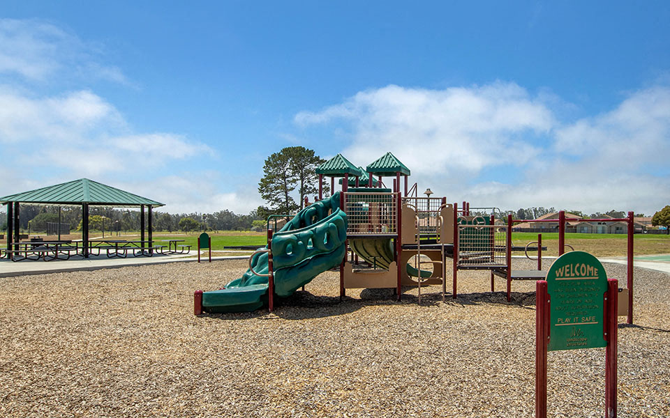 a playground with a slide and other playground equipment