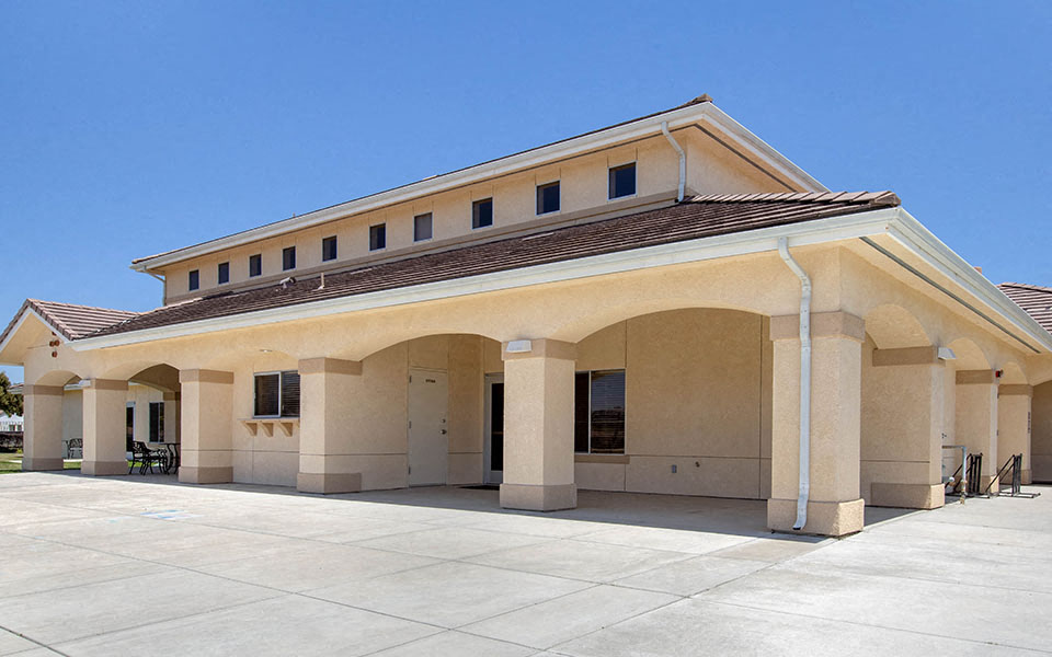 the front of a building with columns and a roof